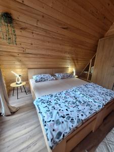 a bedroom with a bed in a wooden cabin at Kuća za odmor - Villa Magdalena in Otočac +16 photos
