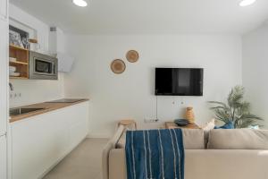a living room with a couch and a table at Sunny Guargacho4 Retreat-South Tenerife in Guargacho