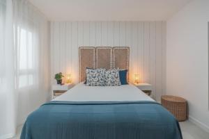 a bedroom with a large bed with blue sheets at Sunny Guargacho4 Retreat-South Tenerife in Guargacho