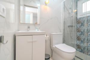 a white bathroom with a toilet and a shower at Sunny Guargacho4 Retreat-South Tenerife in Guargacho