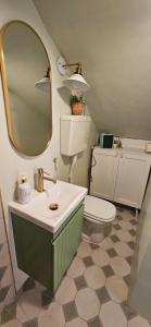 a bathroom with a sink and a toilet and a mirror at Lola's Sanremo Centro in Sanremo +39 photos
