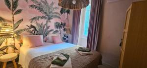 a hotel room with a bed with towels on it at Lola's Sanremo Centro in Sanremo