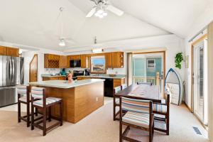 a kitchen with wooden cabinets and a table and chairs at 8396 - White Dune in Avon
