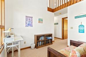 a living room with a bed and a desk at 8396 - White Dune in Avon +40 photos