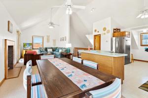 a kitchen and living room with a wooden table at 8396 - White Dune in Avon