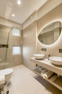 a bathroom with two sinks and a mirror at Hotel Bella Vista in Orikum +47 photos