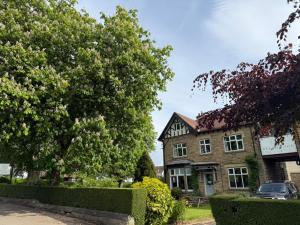 a house with a tree in front of it at The Beechwood in Leeds