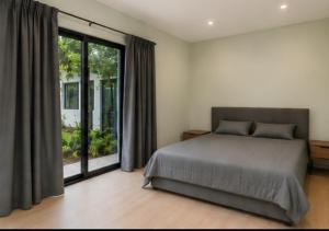 a bedroom with a bed and a large window at Monteverde House in Monteverde Costa Rica