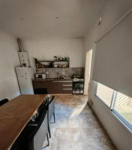 a kitchen with a table and a counter in a room at Depto Civora 1 in Villa Regina