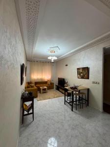 a living room with a couch and a table at Cozy two bedroom apartment in Meknès