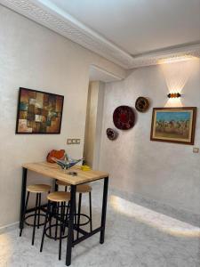 a room with a table and some plates on the wall at Cozy two bedroom apartment in Meknès