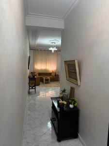 a hallway with a living room with a couch at Cozy two bedroom apartment in Meknès