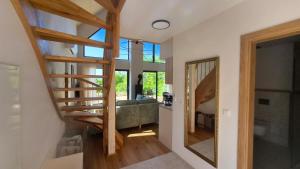 a living room with a staircase and a mirror at Chata Vista in Rožnov pod Radhoštěm +31 photos