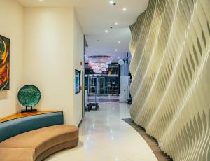 a hallway with a curved wall in a building at HS HOTSSON Hotel Queretaro in Querétaro +63 photos