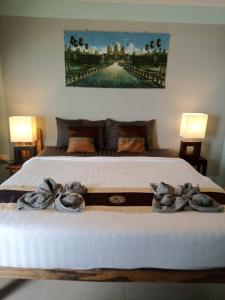 a bedroom with a bed with towels on it at Rock sand Resort in Trat +35 photos