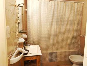 a bathroom with a sink and a toilet and a shower at Kumen Apart de Playa in San Bernardo +166 photos