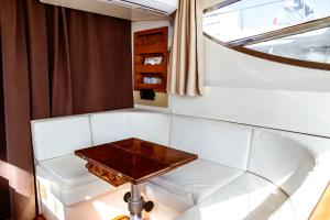 a white couch with a table in a room at BALI house boat in SantʼAntìoco +27 photos