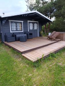 a large wooden deck in front of a house at Kolkja Holiday Centre -Kolkja Puhkeküla in Kolkja +7 photos