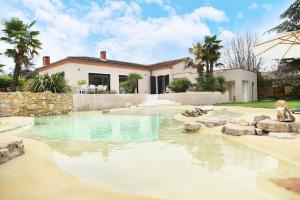 a swimming pool in front of a house at Villa Marius in Albi