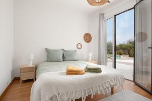 a white bedroom with a bed and a large window at Villa Marius in Albi +22 photos