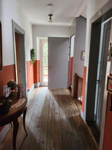 an empty hallway with a wooden floor and a door at Gasthaus Crestasee in Flims
