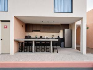 a large kitchen with a counter and a refrigerator at Casa Rosa in Aguascalientes