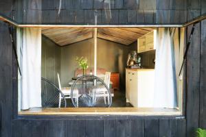 a room with a window with chairs and a table at Minimalist riverside hideout in Riga