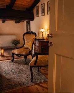 a living room with a chair and a desk at Villa Dorigny Dimora Storica con Affreschi e Giardino in Verona