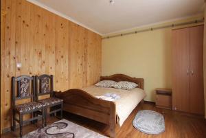 a bedroom with a bed and wooden walls at Форесок in Vorokhta