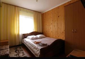 a bedroom with a bed with a window at Форесок in Vorokhta