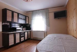 a bedroom with a large bed and a window at Форесок in Vorokhta