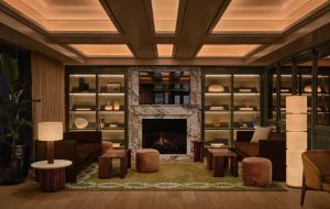 a living room with a couch and a fireplace at Hotel Nelligan in Montreal