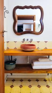a bathroom with a sink and a mirror on a shelf at Pousada Casa de Salim in Lençóis +73 photos