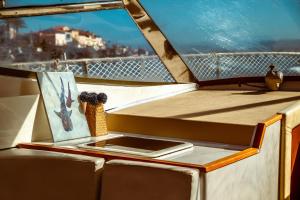 a table with a tablet on a balcony on a boat at BALI house boat in SantʼAntìoco