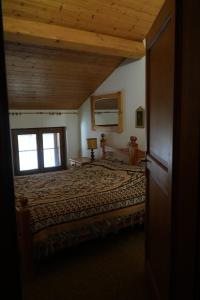 a bedroom with a large bed in a house at Appartamento Villa Rendena in Porte di Rendena
