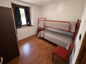 a room with two bunk beds and a window at Maison Jaune 26 in Aosta