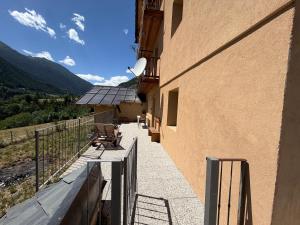 a balcony of a building with a view of a mountain at Maison Jaune 26 in Aosta