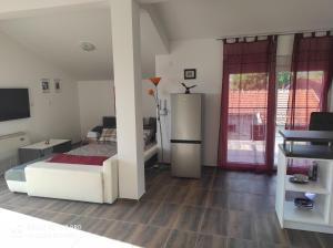 a living room with a bed and a sliding glass door at Villa Yulia in Luštica