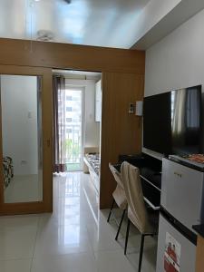 a living room with a kitchen and a dining room at Shell Residences MOA Elegant Place in Manila