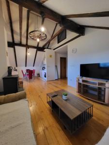 a living room with a coffee table and a flat screen tv at N&M Mountain Escape in Kupres