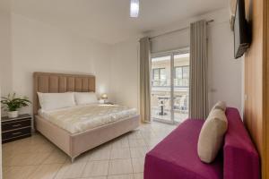 a bedroom with a large bed and a couch at Hotel Bella Vista in Orikum