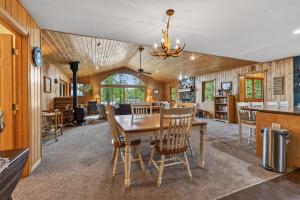 a dining room and kitchen with a table and chairs at Next Chapter Family Retreat in Pequot Lakes