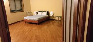a bedroom with a bed and a wooden floor at Portugal Beach Point in Vila Nova de Gaia