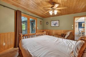 a bedroom with a bed and a ceiling fan at Next Chapter Family Retreat in Pequot Lakes