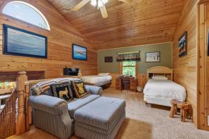 a bedroom with two beds and a couch in a room at Next Chapter Family Retreat in Pequot Lakes