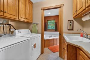 a kitchen with a washing machine and a sink at Next Chapter Family Retreat in Pequot Lakes +13 photos
