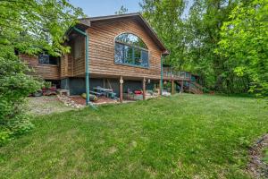 a log home with a deck and a yard at Next Chapter Family Retreat in Pequot Lakes