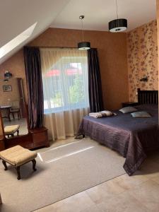 a bedroom with a large bed and a window at Classic Car Museum Apartment in Riga