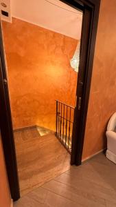 a hallway with an open door and a stairway at B&b MAURO in Gioia Sannitica