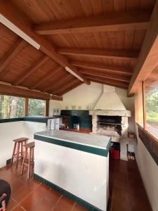a kitchen with a large stone stove in a room at Hotel rústico Aldea Figueiredo in Ourense